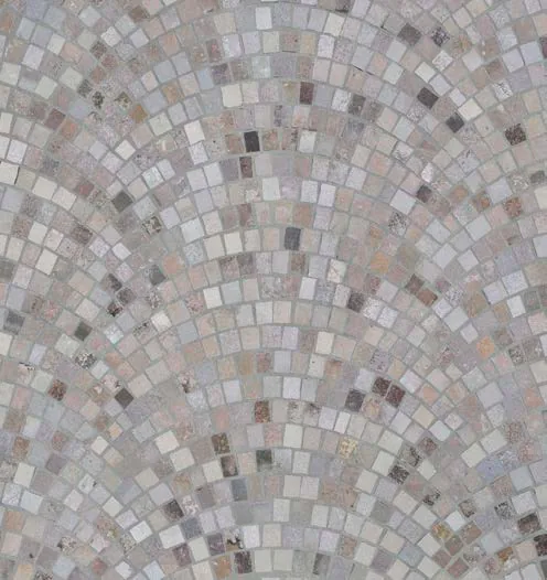 Close-up of Vulcano stone paving laid in arches, in gray and beige tones